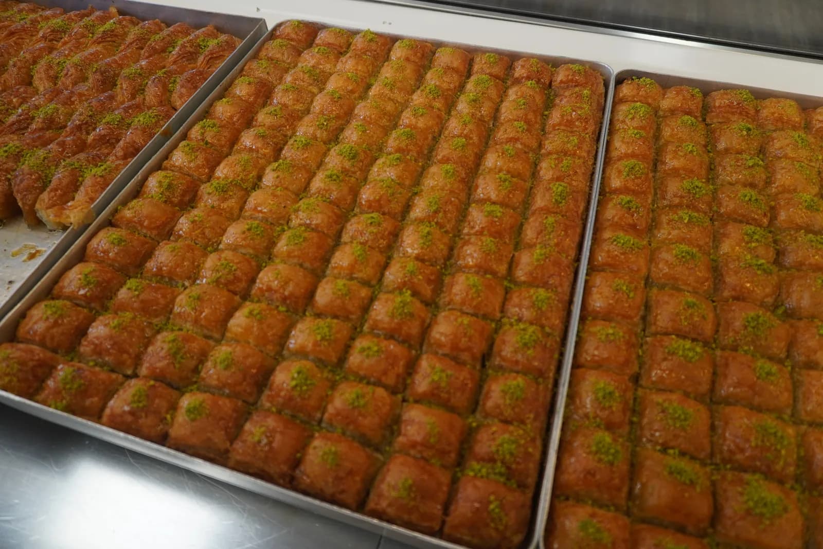 Fertig gebackene Baklava wird auf dem Blech in gleichmäßige Stücke geschnitten